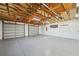 Large three-car garage featuring an unfinished ceiling, concrete flooring, and a mini-split system at 806 Linwood Ter, Lutz, FL 33549