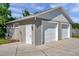 Detached garage with two bays, side door, and concrete driveway at 806 Linwood Ter, Lutz, FL 33549