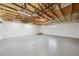 Spacious unfinished garage with high ceilings, exposed beams, and ample room for storage at 806 Linwood Ter, Lutz, FL 33549