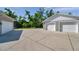 Wide shot of the concrete driveway between the home and detached garage at 806 Linwood Ter, Lutz, FL 33549