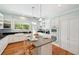The kitchen features an island, hardwood floors, light blue walls, stainless steel appliances and countertops at 806 Linwood Ter, Lutz, FL 33549