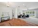 Well-lit living room featuring hardwood floors and plush carpeting with double french doors at 806 Linwood Ter, Lutz, FL 33549