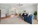 Open-concept living room with hardwood floors, plush carpet, and direct access to the outdoor spaces at 806 Linwood Ter, Lutz, FL 33549