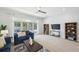 Cozy living room with neutral decor, featuring comfortable seating, built in shelving and lots of natural light at 806 Linwood Ter, Lutz, FL 33549