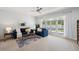 Bright living room with large windows, comfortable seating, and direct access to the outdoor patio at 806 Linwood Ter, Lutz, FL 33549