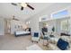 Bright main bedroom with a ceiling fan, lots of natural light, a comfortable bed, and a sitting area at 806 Linwood Ter, Lutz, FL 33549