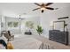 Spacious main bedroom with two ceiling fans, lots of natural light, a dresser, and a comfortable bed at 806 Linwood Ter, Lutz, FL 33549