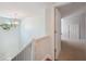 Staircase with railing, and natural lighting from a diamond-shaped window at 806 Linwood Ter, Lutz, FL 33549