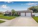Attractive single story brick home featuring a two-car garage and meticulously maintained landscaping at 8845 123Rd Way, Seminole, FL 33772