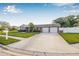 Well-kept brick home with a two car garage, nice front yard, and a paved driveway at 8845 123Rd Way, Seminole, FL 33772