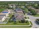 Aerial view of several homes with well-manicured lawns, mature landscaping and community streets at 9107 Gablewood Pl, Land O Lakes, FL 34638