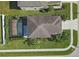 Aerial view of a home featuring a private screened-in pool, lush lawn, mature trees, and a paved walkway at 9107 Gablewood Pl, Land O Lakes, FL 34638