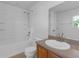 Bathroom featuring a single vanity sink, a shower-tub combo, and tiled flooring at 9107 Gablewood Pl, Land O Lakes, FL 34638