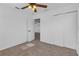 A secondary bedroom with a fan, closet, and door leading to another room at 9107 Gablewood Pl, Land O Lakes, FL 34638