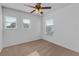 A light and airy secondary bedroom with carpet flooring and a fan at 9107 Gablewood Pl, Land O Lakes, FL 34638