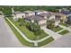 Two-story home boasts a well-manicured lawn, mature landscaping, and a paved driveway leading to an attached two-car garage at 9107 Gablewood Pl, Land O Lakes, FL 34638