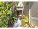 Covered front entrance with lush landscaping at 9107 Gablewood Pl, Land O Lakes, FL 34638