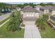 Charming two-story home showcases a neutral color palette, arched windows, and a two-car garage at 9107 Gablewood Pl, Land O Lakes, FL 34638