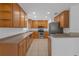Kitchen with stainless steel appliances and wood cabinetry, offering a functional layout at 9107 Gablewood Pl, Land O Lakes, FL 34638