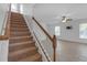 Open living room and stairwell area with tile flooring, neutral paint, and ceiling fan at 9107 Gablewood Pl, Land O Lakes, FL 34638