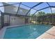 View of screened-in pool and rear of home with brick pavers at 9107 Gablewood Pl, Land O Lakes, FL 34638