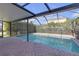 Screened-in pool area features a brick-paved patio at 9107 Gablewood Pl, Land O Lakes, FL 34638