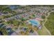 A community features a sparkling blue pool, clubhouse, and green spaces near a lake at 9205 English Oaks Ln, Riverview, FL 33578
