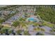 Community featuring homes, a sparkling blue pool, clubhouse, and green spaces at 9205 English Oaks Ln, Riverview, FL 33578