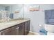 Bathroom featuring a double vanity with granite countertop and modern fixtures at 9205 English Oaks Ln, Riverview, FL 33578