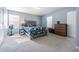 Bright bedroom with neutral carpet, two windows, and a decorative bedspread with matching pillows at 9205 English Oaks Ln, Riverview, FL 33578