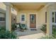 Charming front porch with potted plants, a chair and a welcoming welcome sign at 9205 English Oaks Ln, Riverview, FL 33578