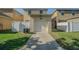 Attached garage with a white door and a driveway, providing convenient parking at 9205 English Oaks Ln, Riverview, FL 33578