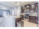 Well-lit kitchen features granite counters, stainless appliances, and easy access to living spaces at 9205 English Oaks Ln, Riverview, FL 33578