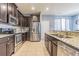 Modern kitchen with stainless steel appliances, granite countertops and dark wood cabinetry at 9205 English Oaks Ln, Riverview, FL 33578