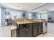 The kitchen features a breakfast bar, granite countertops, and stainless steel appliances at 9205 English Oaks Ln, Riverview, FL 33578