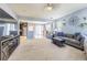Open concept living room featuring plush seating, a ceiling fan and an eat-in kitchen at 9205 English Oaks Ln, Riverview, FL 33578