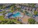 Aerial view of a neighborhood clubhouse featuring a pool, playground, and basketball court at 9205 English Oaks Ln, Riverview, FL 33578