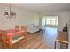 Bright and open living room with wood look flooring and comfortable furniture at 940 Virginia St # 304, Dunedin, FL 34698