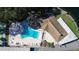 Birds eye view of a sparkling pool, deck, tennis court, and clubhouse at 940 Virginia St # 304, Dunedin, FL 34698