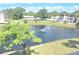 Water view of the fountain in the pond with lush foliage and blue sky at 940 Virginia St # 304, Dunedin, FL 34698