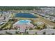 Aerial view of community pool, tennis courts, recreation center and lake at 11426 Sage Canyon Dr, Riverview, FL 33578
