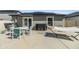 Backyard with an outdoor kitchen and patio area with a hammock and dining area at 11426 Sage Canyon Dr, Riverview, FL 33578