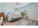 Bedroom features modern ceiling fan, gray flooring, and a comfortable bed with natural light at 11426 Sage Canyon Dr, Riverview, FL 33578