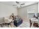 Bright bedroom with two armchairs, storage chest, and neutral walls at 11426 Sage Canyon Dr, Riverview, FL 33578