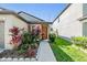 Charming single-Gathering home featuring a landscaped front yard with mature shrubs and colorful plants at 11426 Sage Canyon Dr, Riverview, FL 33578