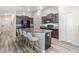 Open kitchen featuring a large island with seating, stainless steel appliances, and ample storage space at 11426 Sage Canyon Dr, Riverview, FL 33578