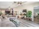 Bright living room featuring modern gray flooring, stylish sectional sofa, and a view to the kitchen at 11426 Sage Canyon Dr, Riverview, FL 33578