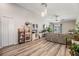 Open living room design featuring gray flooring, a modern ceiling fan, and access to the backyard at 11426 Sage Canyon Dr, Riverview, FL 33578