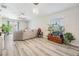 Bright living room with a view to the backyard and features stylish gray flooring and a cozy sectional sofa at 11426 Sage Canyon Dr, Riverview, FL 33578