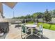 Outdoor patio featuring a table with four chairs, a grill, and a hammock at 11426 Sage Canyon Dr, Riverview, FL 33578